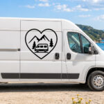 Sticker en forme de cœur avec un van, deux arbres et des montagnes en arrière-plan