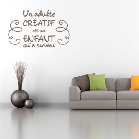 Sticker mural texte "Un adulte créatif est un enfant qui a survécu" avec ornements décoratifs